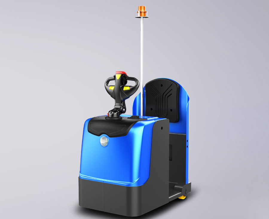 New Energy Forklift BYD Stand-On Towing Tractor BYD Electric Stand-On Towing Tractor navigating a narrow warehouse aisle with a heavy cargo trailer